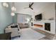 Well-lit living room featuring a fireplace, a large sectional sofa, and contemporary design elements for comfortable living at 2918 Wessex St, Orlando, FL 32803