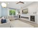 Bright living room with a large window, comfortable sectional sofa, and a modern fireplace feature wall at 2918 Wessex St, Orlando, FL 32803