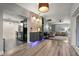 Contemporary open-concept layout featuring stylish lighting fixtures connecting the living room and stainless steel kitchen at 2918 Wessex St, Orlando, FL 32803