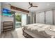 Bright main bedroom with sliding glass doors to the pool area and a large wall-mounted television at 2918 Wessex St, Orlando, FL 32803