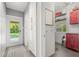 Mud room with pool access, featuring gray tile, white cabinets, and a rear entry door at 2918 Wessex St, Orlando, FL 32803