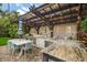 Outdoor kitchen features a built-in grill, dining area, bar seating, and stylish countertops at 2918 Wessex St, Orlando, FL 32803