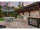 Beautiful outdoor kitchen area with a dining set, lush landscaping, and ample space for entertaining by the pool at 2918 Wessex St, Orlando, FL 32803