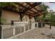 Modern outdoor kitchen with stainless steel grill, sink, storage, and bar with stone countertops at 2918 Wessex St, Orlando, FL 32803