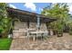 Outdoor kitchen featuring a built-in grill, countertop space, and a pergola-covered dining area at 2918 Wessex St, Orlando, FL 32803
