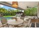Cozy outdoor patio includes an outdoor kitchen, swimming pool, ceiling fan, and an exterior dining table at 2918 Wessex St, Orlando, FL 32803