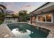 Inviting pool with outdoor kitchen, covered patio, and lush tropical landscaping creates an ideal backyard oasis at 2918 Wessex St, Orlando, FL 32803