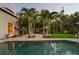 Sparkling backyard pool surrounded by lush tropical landscaping with paver patio and room for entertaining at 2918 Wessex St, Orlando, FL 32803