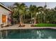 Private pool with lush tropical landscaping creates a serene oasis in this backyard retreat at 2918 Wessex St, Orlando, FL 32803