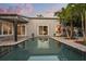 Backyard pool offering access to the home's bedrooms, patio area, and lush tropical landscaping at 2918 Wessex St, Orlando, FL 32803