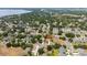 Aerial view of a two-story house surrounded by lush trees in a quiet neighborhood at 294 Hunt St, Clermont, FL 34711