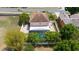 Aerial view of a two-story house featuring an in-ground pool and a long driveway at 294 Hunt St, Clermont, FL 34711