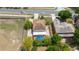 Aerial view of a two-story house featuring an in-ground pool and a long driveway at 294 Hunt St, Clermont, FL 34711