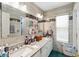 Bathroom with double sinks, large mirrors, and tiled walls with decorative black accent at 294 Hunt St, Clermont, FL 34711