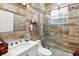Modern bathroom with mosaic tile accents, a glass shower, and updated fixtures at 294 Hunt St, Clermont, FL 34711