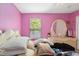 Bedroom featuring pink walls, a window overlooking the outside, and an ornate vanity at 294 Hunt St, Clermont, FL 34711