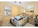 Bedroom featuring yellow walls, ceiling fan and mirror at 294 Hunt St, Clermont, FL 34711