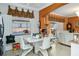 Bright dining area adjacent to pool with white modern chairs, hard wood floors and neutral walls at 294 Hunt St, Clermont, FL 34711