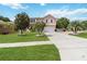 Charming two-story home with lush landscaping, palm trees, and a spacious driveway at 294 Hunt St, Clermont, FL 34711