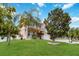 Beautiful home with lush landscaping and mature trees in a serene setting at 294 Hunt St, Clermont, FL 34711