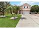 Inviting two-story home with manicured lawn and stone-lined palm trees at 294 Hunt St, Clermont, FL 34711