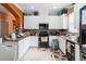 Bright kitchen featuring white cabinets, tile backsplash, granite countertops and stainless steel appliances at 294 Hunt St, Clermont, FL 34711