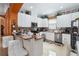 Bright kitchen with white cabinets, tile backsplash, stainless steel appliances, and breakfast bar seating at 294 Hunt St, Clermont, FL 34711