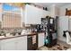Bright kitchen featuring white cabinets, tile backsplash, granite countertops and stainless steel appliances at 294 Hunt St, Clermont, FL 34711