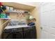 A functional laundry room with modern Samsung washer and dryer and ample shelf storage at 294 Hunt St, Clermont, FL 34711