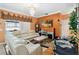Inviting living room with orange walls, chandelier, fireplace, and comfortable white leather sectional sofa at 294 Hunt St, Clermont, FL 34711