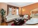 Elegant living room featuring hardwood floors, decorative curtains and ornate furniture at 294 Hunt St, Clermont, FL 34711