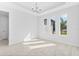 Elegant dining room with chandelier, tray ceiling, and three large windows at 354 Miller Rd, Sanford, FL 32773