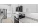 Modern kitchen featuring stainless steel appliances, granite countertops, and white cabinets at 354 Miller Rd, Sanford, FL 32773