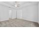 Spacious main bedroom featuring plush carpet, tray ceiling, and natural light at 354 Miller Rd, Sanford, FL 32773