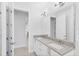 Bright bathroom featuring a granite countertop, double sinks and modern fixtures at 371 Miller Rd, Sanford, FL 32773