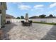 Spacious backyard features a large patio with outdoor seating, perfect for entertaining and relaxation at 3842 Klondike Pl, Sanford, FL 32771
