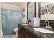 Bathroom featuring double sink vanity with dark wood cabinets and framed mirrors, offering a touch of elegance at 3842 Klondike Pl, Sanford, FL 32771