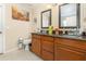 Bathroom featuring double sinks with granite countertops and wooden cabinets at 3842 Klondike Pl, Sanford, FL 32771