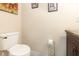 Half-bath with a toilet and small cabinet with a dark countertop at 3842 Klondike Pl, Sanford, FL 32771