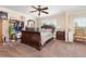 Spacious bedroom with ceiling fan, carpet, and large window, providing comfort and plenty of natural light at 3842 Klondike Pl, Sanford, FL 32771