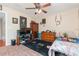 This bedroom has a ceiling fan, carpet, and dresser with TV on top, offering comfort and entertainment at 3842 Klondike Pl, Sanford, FL 32771