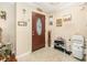Foyer with tile flooring, decorative accents, and a dark wood front door with glass at 3842 Klondike Pl, Sanford, FL 32771