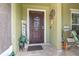 Inviting front porch featuring decorative accents, tiled flooring and a seating area at 3842 Klondike Pl, Sanford, FL 32771