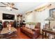 Comfortable living room with a leather sofa, a fireplace, and wood flooring at 3842 Klondike Pl, Sanford, FL 32771