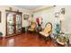 Cozy living room with wood flooring, comfortable seating, and a glass display case at 3842 Klondike Pl, Sanford, FL 32771