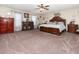 Spacious main bedroom featuring a king-size bed, dark wood furniture, and a ceiling fan at 3842 Klondike Pl, Sanford, FL 32771