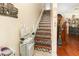 Staircase with wood and mosaic tile steps and a stair lift for accessibility at 3842 Klondike Pl, Sanford, FL 32771