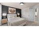 Contemporary bedroom featuring a queen bed, a nightstand with a lamp, and access to an en-suite bathroom at 393 Meadowland Pt, Oviedo, FL 32765