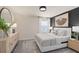 A modern bedroom with stylish furnishings, including a dresser, queen bed, and neutral decor at 393 Meadowland Pt, Oviedo, FL 32765