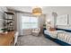 Bright room featuring a desk, bookshelves, daybed, a natural pendant light, and large window at 393 Meadowland Pt, Oviedo, FL 32765